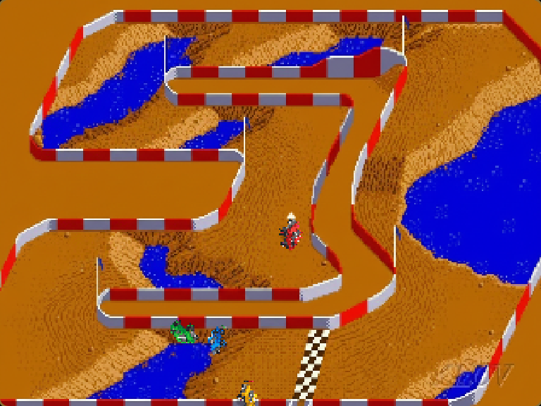 Four trucks on the orange dirt inside the red and white barriers after a long W cruise